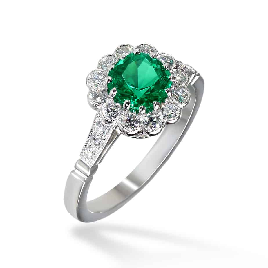 Cushion cut emerald and diamond cluster ring