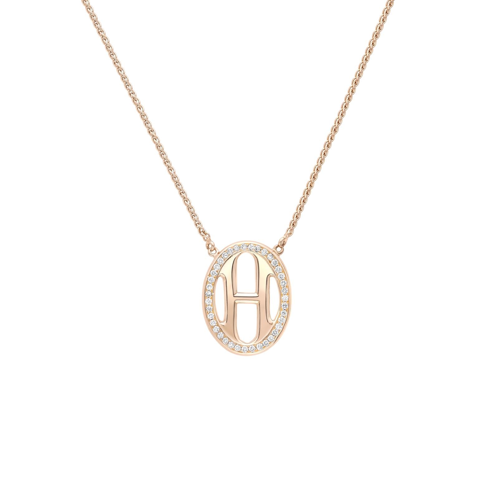 18ct yellow gold H pendant with diamond surround