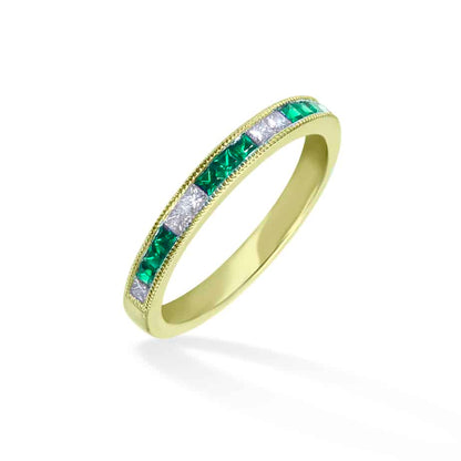 Princess cut emerald and diamond channel set half eternity ring