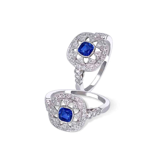 Cushion cut sapphire and diamond space ring
