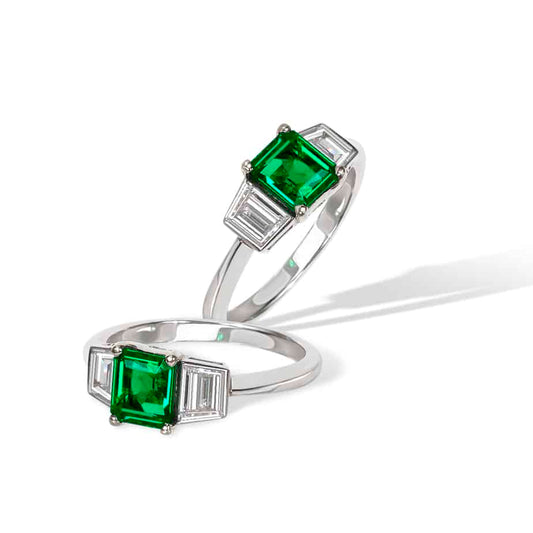 Emerald cut emerald and trapeze cut diamond ring