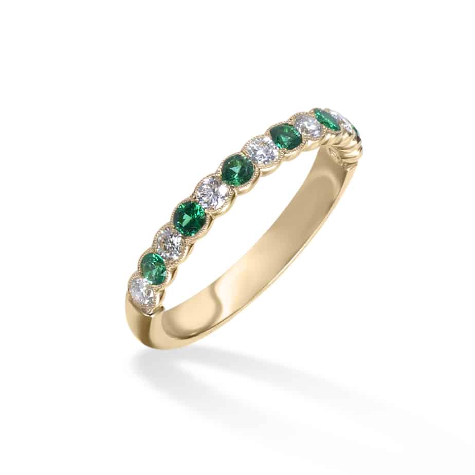 Emerald and diamond cup half eternity ring
