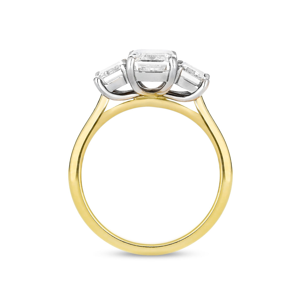 Emerald cut diamond three stone ring in 18ct yellow gold and platinum, side view