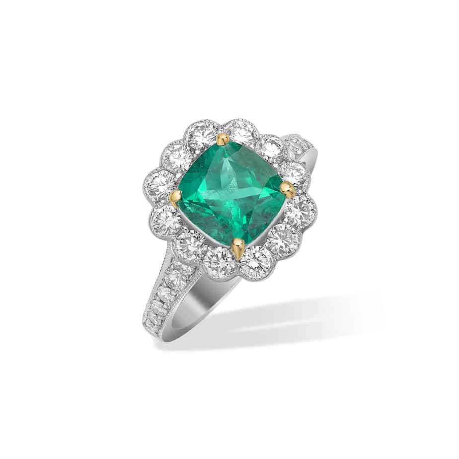Cushion cut emerald and diamond cluster ring